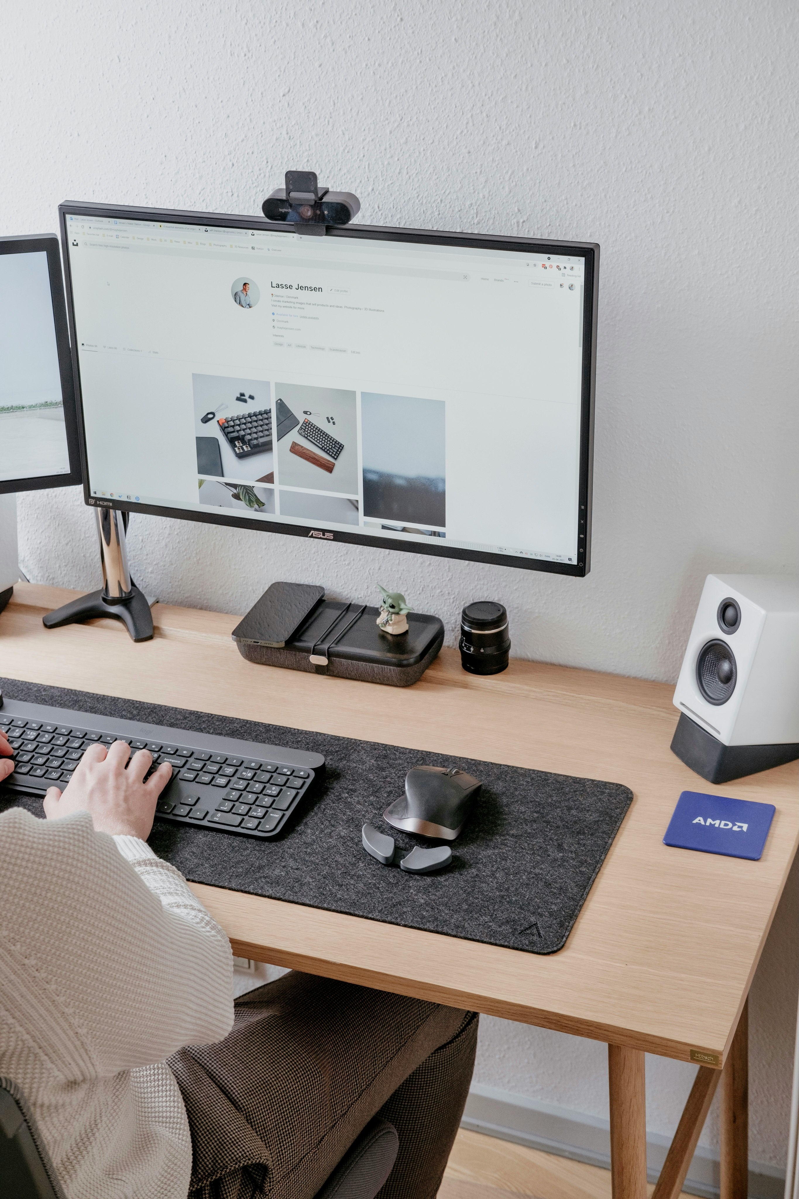 person using computer on brown wooden desk